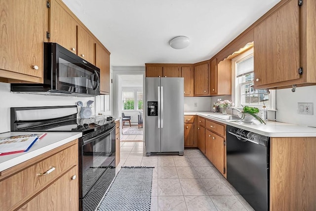 209 Brookside Rd, Needham, MA 02492 - kitchen featuring black appliances, plenty of natural light, light countertops, and brown cabinets