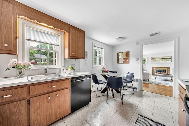 209 Brookside Rd, Needham, MA 02492 - kitchen with dishwasher, light countertops, a fireplace, and light tile patterned flooring