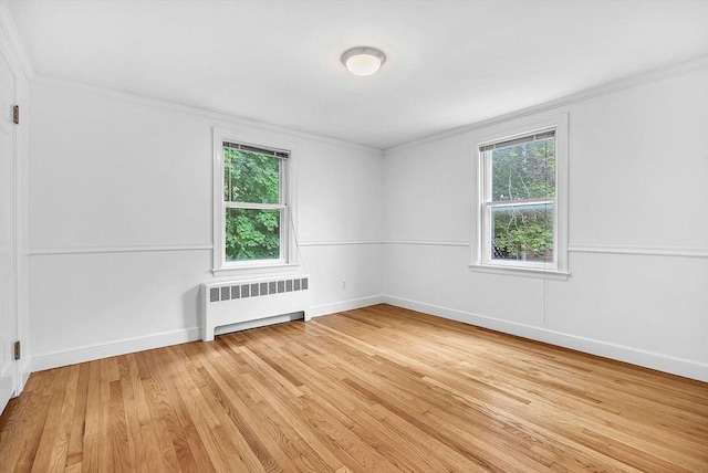 209 Brookside Rd, Needham, MA 02492 - empty room featuring radiator heating unit, light wood-style floors, and ornamental molding