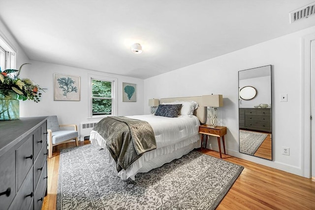 209 Brookside Rd, Needham, MA 02492 - bedroom with radiator heating unit and light wood-style floors