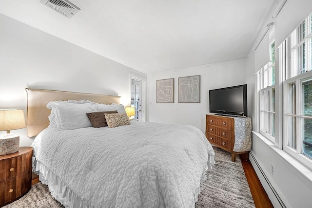 209 Brookside Rd, Needham, MA 02492 - bedroom featuring wood finished floors and a baseboard radiator