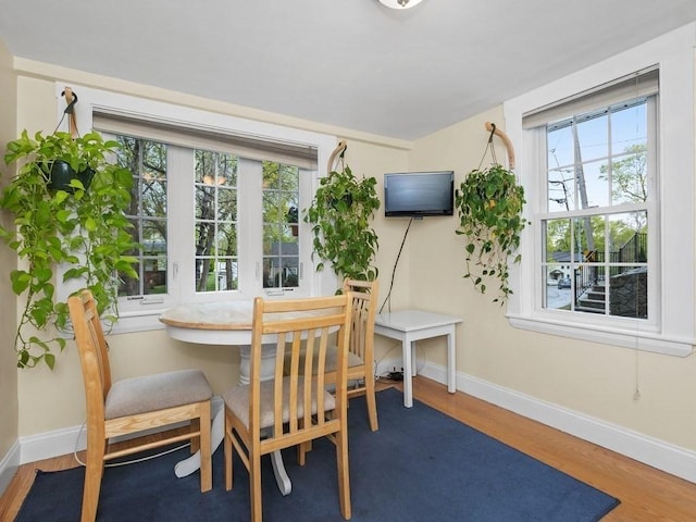 dining area featuring plenty of natural light, baseboards, and wood finished floors