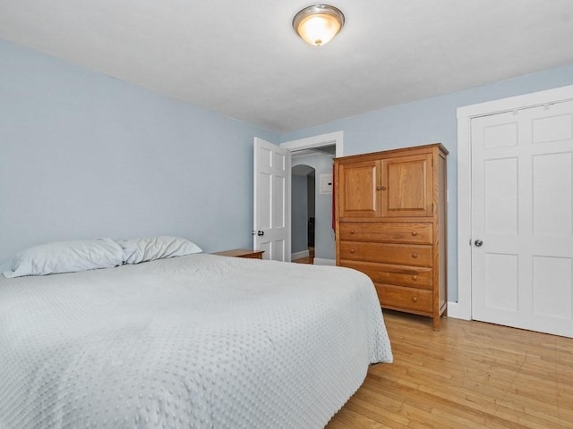 bedroom featuring baseboards and light wood-style flooring