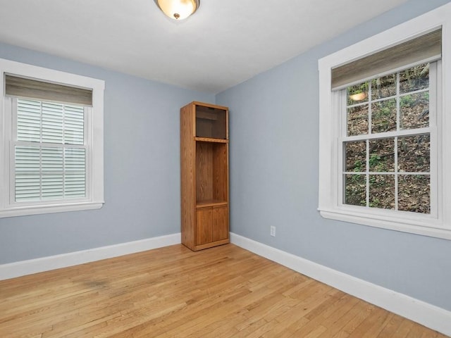 unfurnished bedroom featuring baseboards and light wood-type flooring