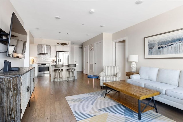 living room with dark hardwood / wood-style flooring