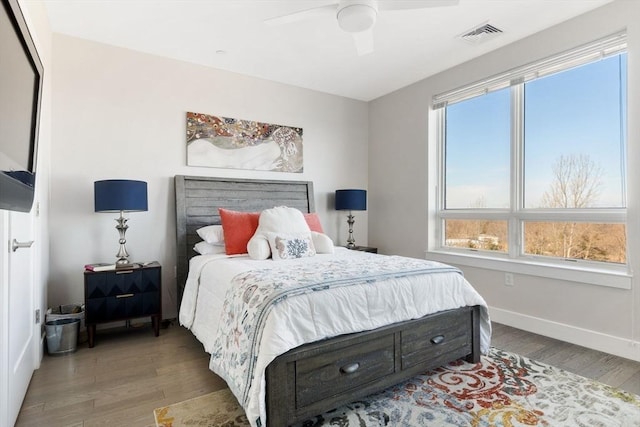 bedroom with ceiling fan and wood-type flooring