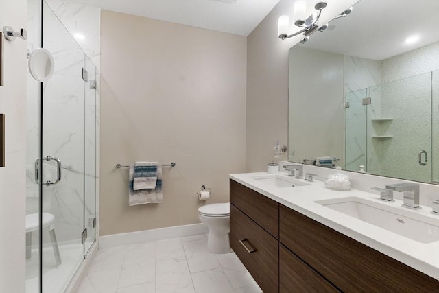 bathroom with vanity, toilet, and a shower with door