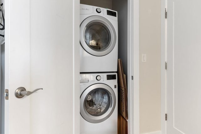 washroom featuring stacked washer / dryer