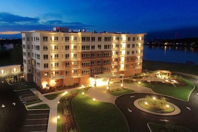 outdoor building at dusk featuring a water view