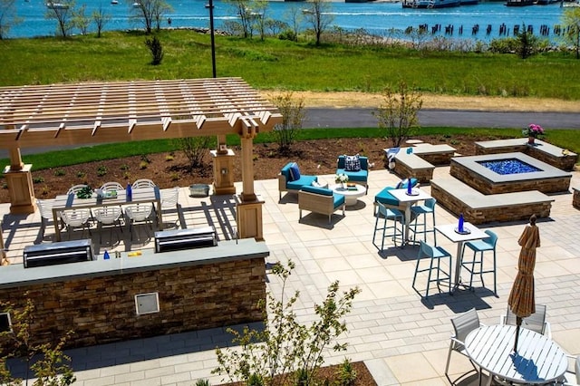 view of patio / terrace with a water view and a fire pit