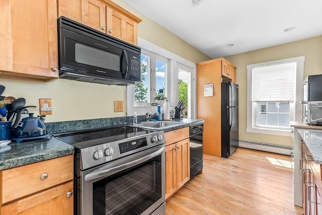 129 Vernon St Unit B, Norwood, MA 02062 - kitchen featuring black appliances, a sink, baseboard heating, light wood-style flooring, and dark countertops