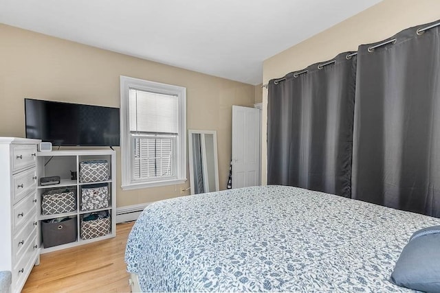 129 Vernon St Unit B, Norwood, MA 02062 - bedroom with light wood-type flooring and a baseboard heating unit