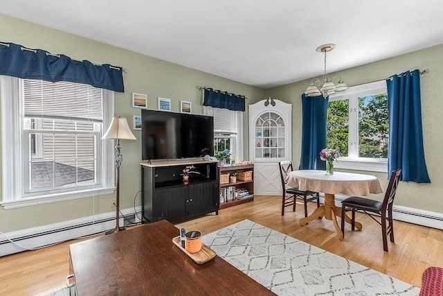 129 Vernon St Unit B, Norwood, MA 02062 - living area with light wood-type flooring, baseboard heating, and a chandelier
