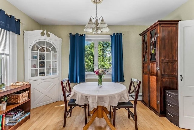 129 Vernon St Unit B, Norwood, MA 02062 - dining area with a chandelier, a baseboard radiator, and light wood-style floors