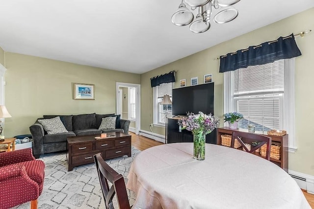 129 Vernon St Unit B, Norwood, MA 02062 - living area featuring baseboard heating, a chandelier, light wood-style floors, and baseboards