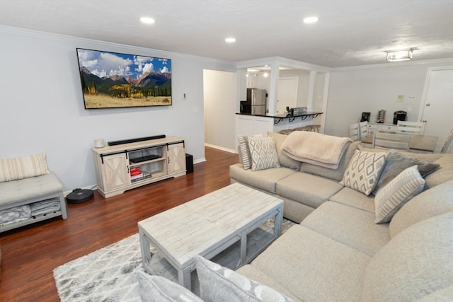 living room with dark hardwood / wood-style floors and crown molding