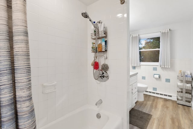 full bathroom with wood-type flooring, a baseboard heating unit, shower / bathtub combination with curtain, tile walls, and toilet