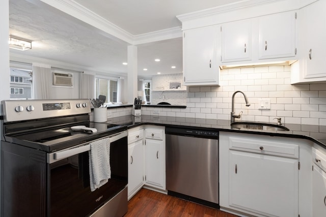 kitchen with decorative backsplash, crown molding, dark hardwood / wood-style flooring, stainless steel appliances, and white cabinetry