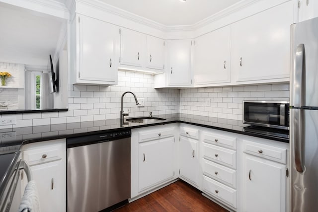 kitchen with white cabinets, sink, backsplash, stainless steel appliances, and dark hardwood / wood-style flooring