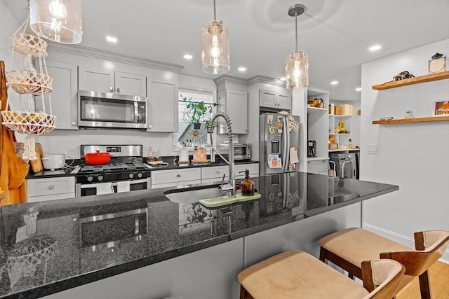 100 Ashland St, Lynn, MA 01905 - kitchen with stainless steel appliances, open shelves, separate washer and dryer, a kitchen bar, and pendant lighting