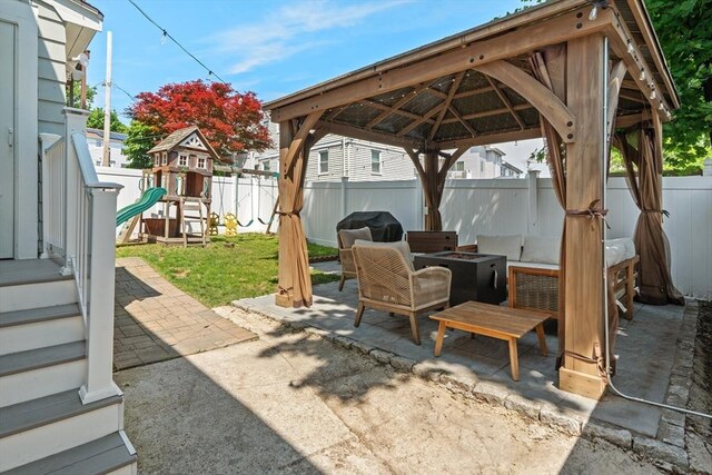 100 Ashland St, Lynn, MA 01905 - fenced backyard featuring a fire pit, a patio area, area for grilling, and a gazebo