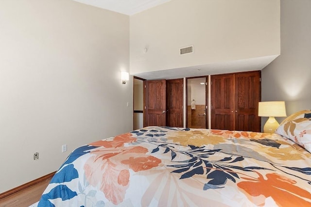 525 Tumbling Hawk Unit 525, Acton, MA 01720 - bedroom featuring wood finished floors, baseboards, and a high ceiling