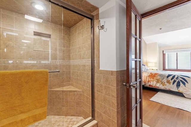 525 Tumbling Hawk Unit 525, Acton, MA 01720 - bathroom featuring a shower stall, wood finished floors, and ensuite bathroom