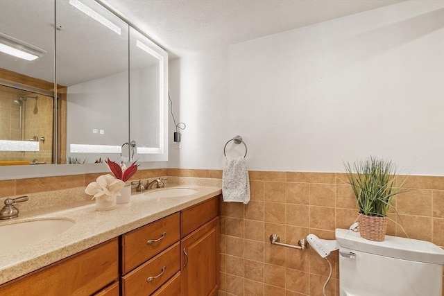 525 Tumbling Hawk Unit 525, Acton, MA 01720 - full bath with double vanity, toilet, tile walls, and a shower with shower door