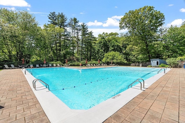 525 Tumbling Hawk Unit 525, Acton, MA 01720 - community pool with a patio and view of wooded area