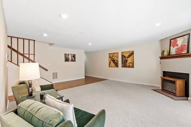 525 Tumbling Hawk Unit 525, Acton, MA 01720 - carpeted living room featuring recessed lighting, stairs, a glass covered fireplace, and baseboards
