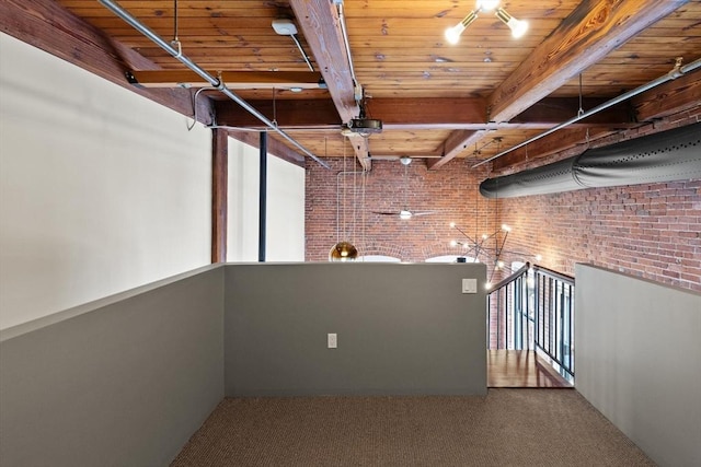 basement featuring carpet flooring, brick wall, and wooden ceiling