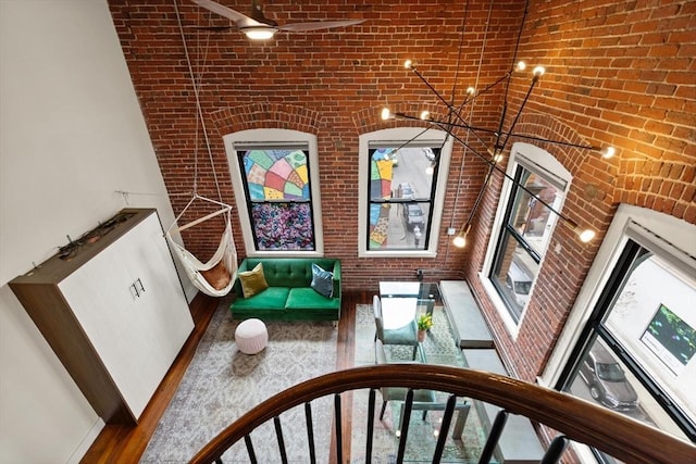 interior space with brick wall and wood finished floors