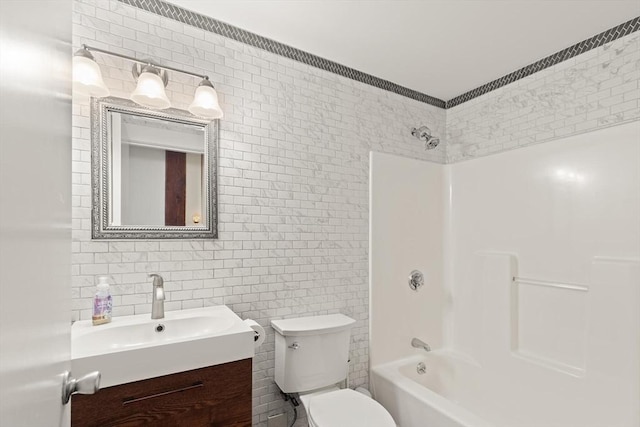 full bathroom featuring vanity, shower / bath combination, toilet, and tile walls