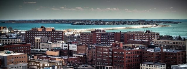 drone / aerial view featuring a water view and a view of city