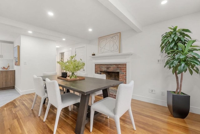 dining area with baseboards, beamed ceiling, light wood-style flooring, and recessed lighting