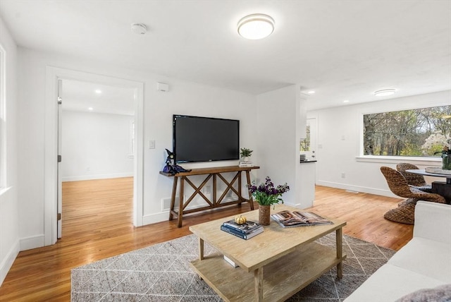 living room with recessed lighting, wood finished floors, and baseboards