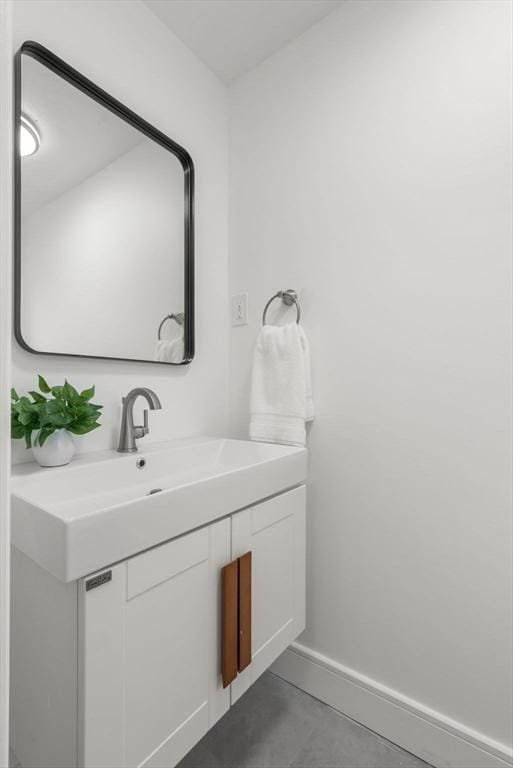 bathroom with tile patterned floors, baseboards, and vanity