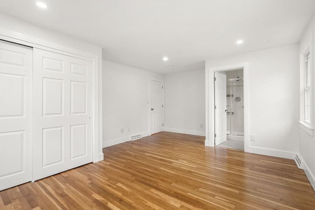 unfurnished bedroom featuring recessed lighting, visible vents, light wood-style flooring, connected bathroom, and baseboards