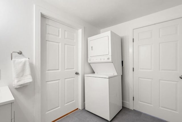 clothes washing area with laundry area and stacked washer / dryer