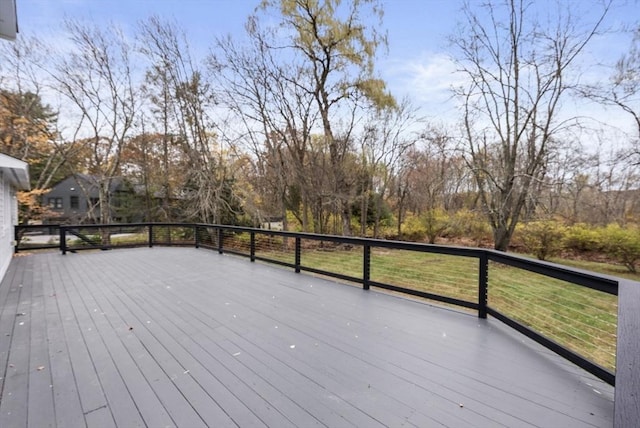 wooden deck featuring a yard