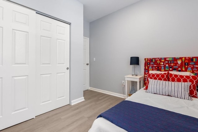 bedroom with wood-type flooring and a closet