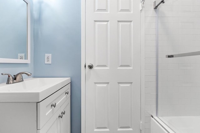 bathroom featuring vanity and shower / bath combination with glass door