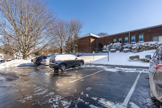 view of snow covered parking area