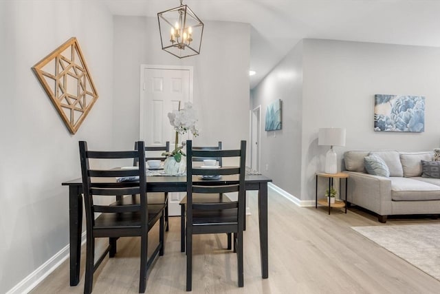 dining room with a chandelier and light hardwood / wood-style floors