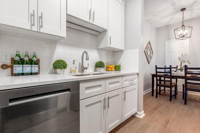 kitchen featuring sink, backsplash, white cabinetry, and dishwasher