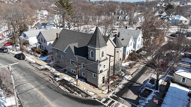 snowy aerial view with a residential view