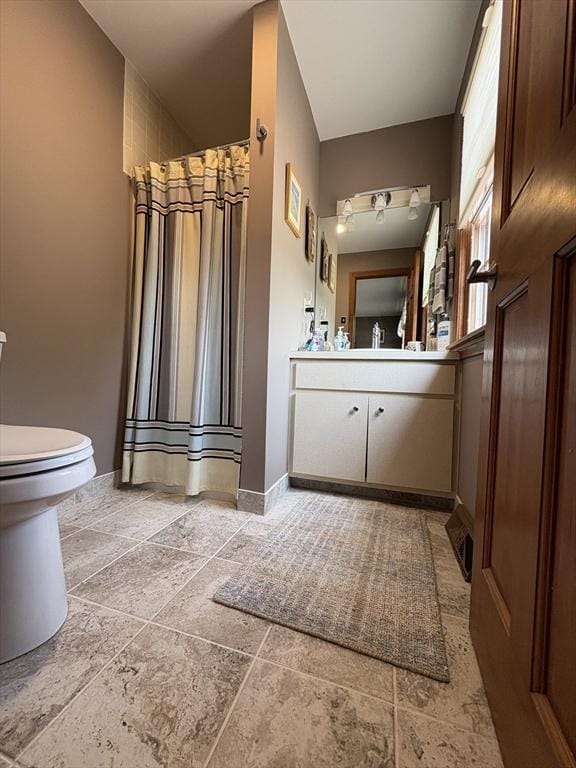 351-355 Main St Unit G, Easthampton, MA 01027 - full bathroom with vanity, stone tile flooring, and a shower with curtain