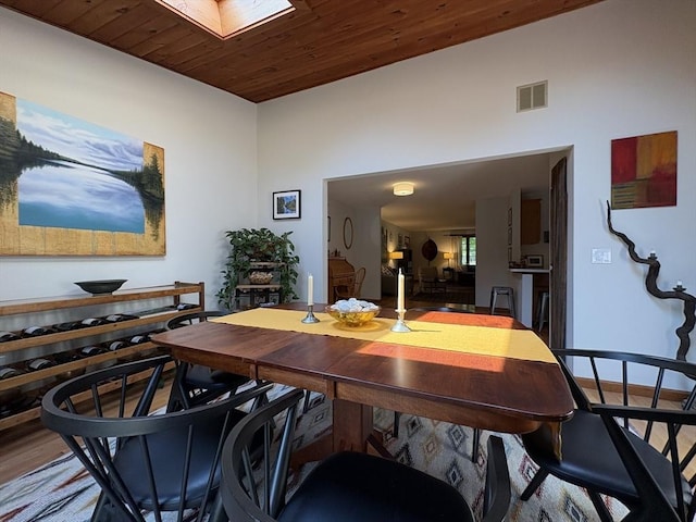 351-355 Main St Unit G, Easthampton, MA 01027 - dining room featuring a skylight, wood ceiling, wood finished floors, and a towering ceiling