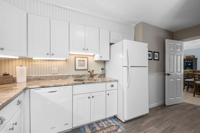 kitchen featuring white appliances, dark wood-style flooring, white cabinets, and a sink