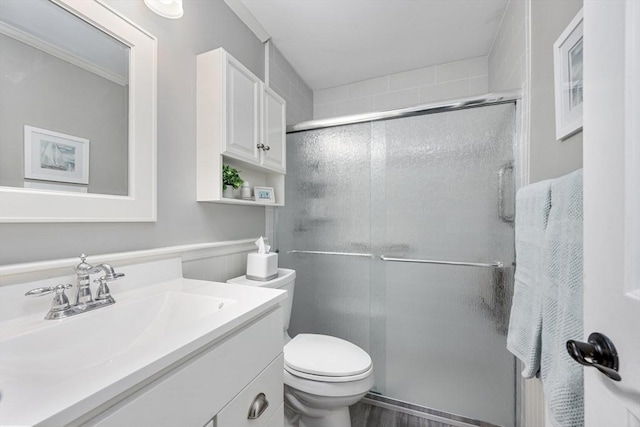 full bathroom with vanity, a stall shower, and toilet